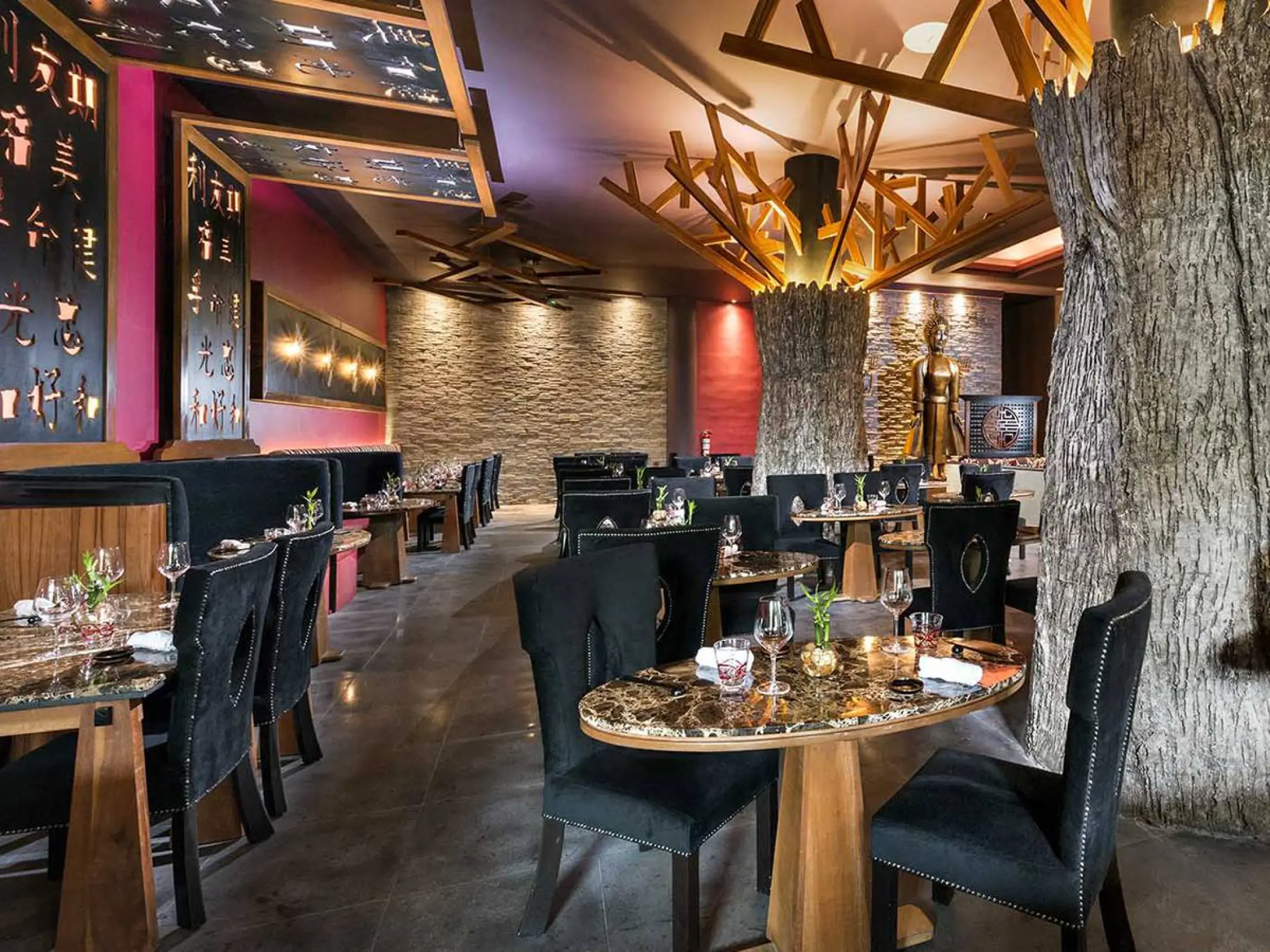 Modern Asian restaurant interior with tree-inspired decor at El Dorado Seaside Palms, Riviera Maya