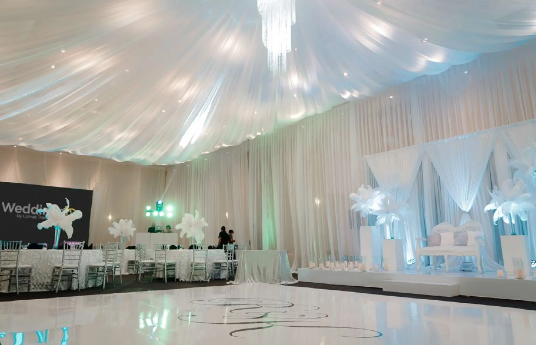 Grand ballroom wedding reception with white draped ceiling and dance floor at El Dorado Seaside Palms, Riviera Maya