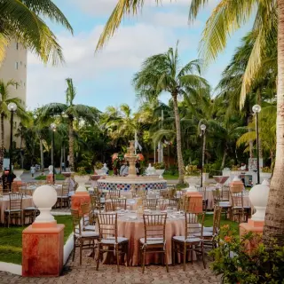 Mexican Plaza wedding reception with round tables and a fountain at El Dorado Seaside Palms, Riviera Maya