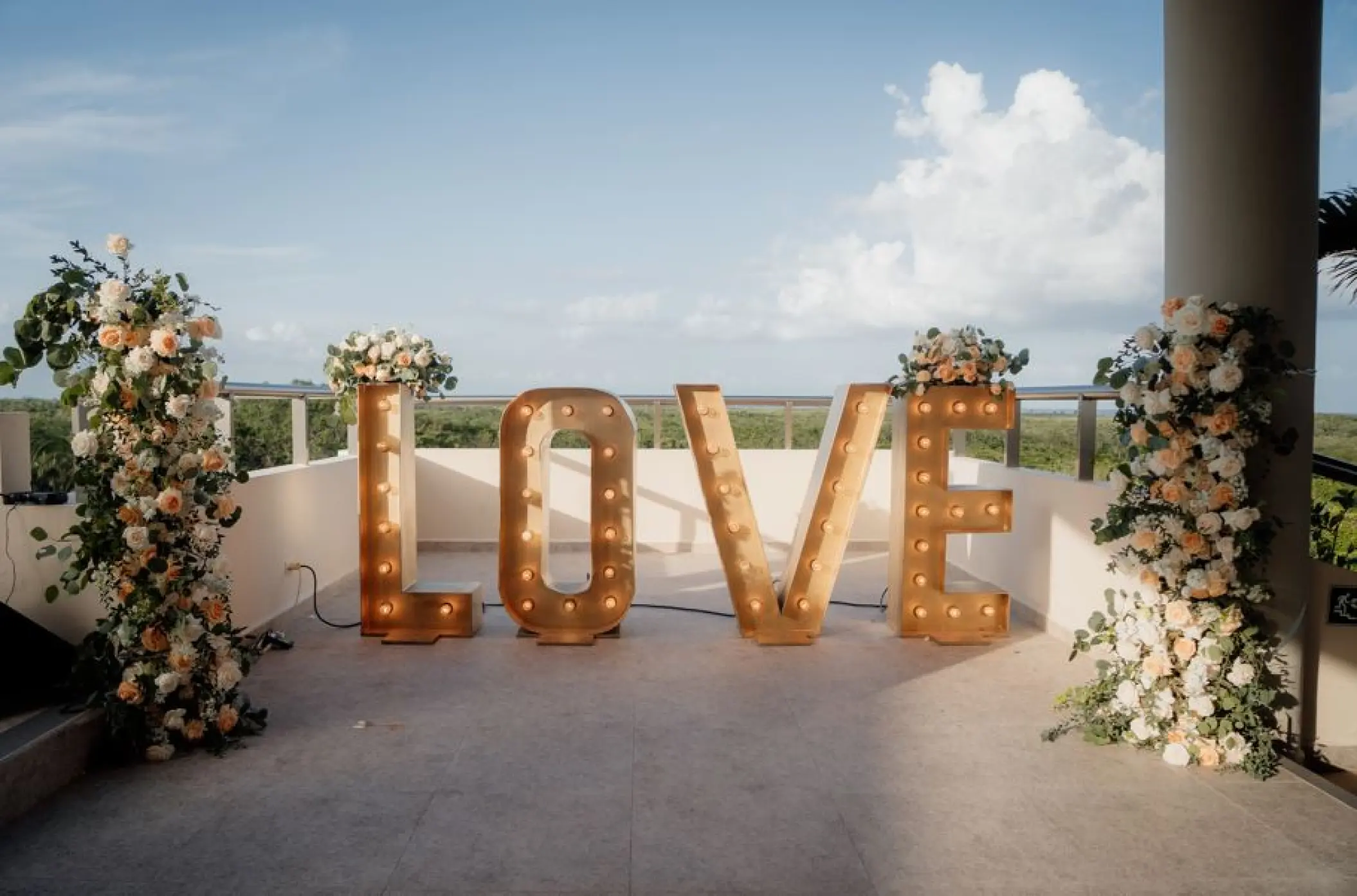 Marquee LOVE letters and floral pillars on the Sky Deck at El Dorado Seaside Palms, Riviera Maya