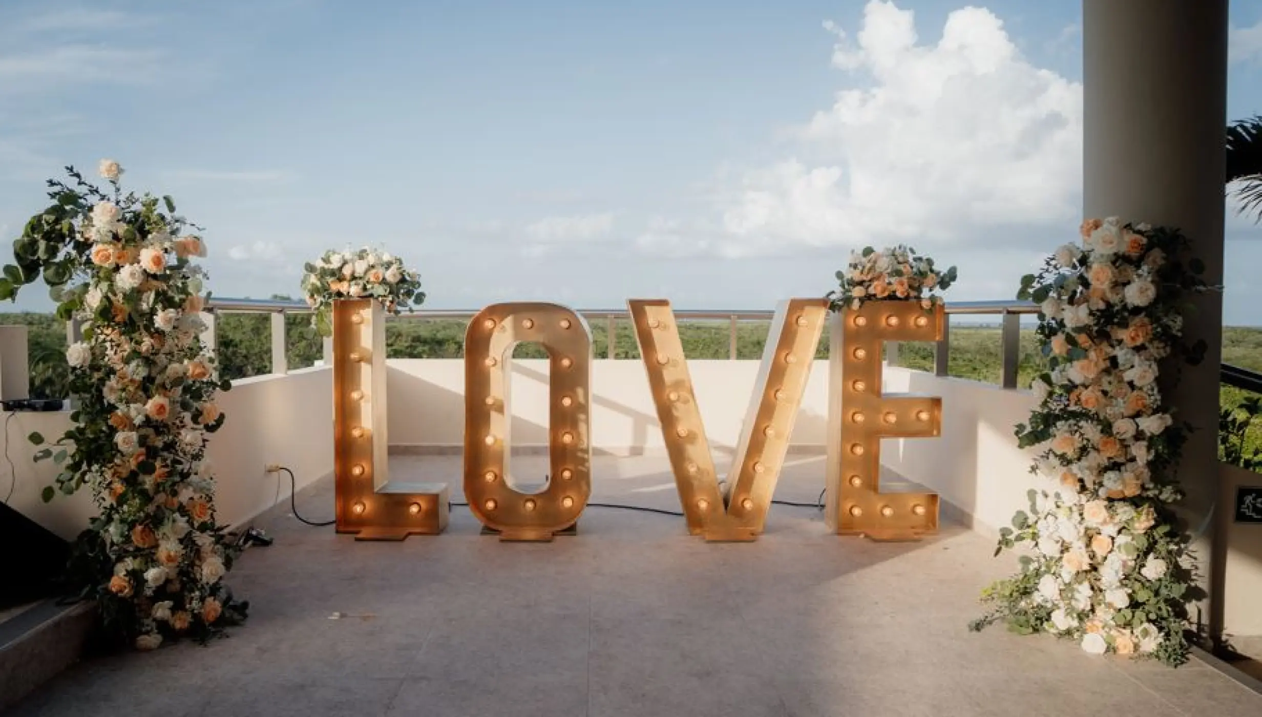 Marquee LOVE letters and floral pillars on the Sky Deck at El Dorado Seaside Palms, Riviera Maya