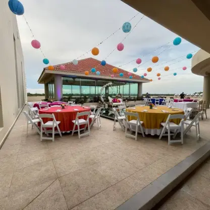 Sky deck wedding reception with colorful lanterns and table linens at El Dorado Seaside Palms, Riviera Maya
