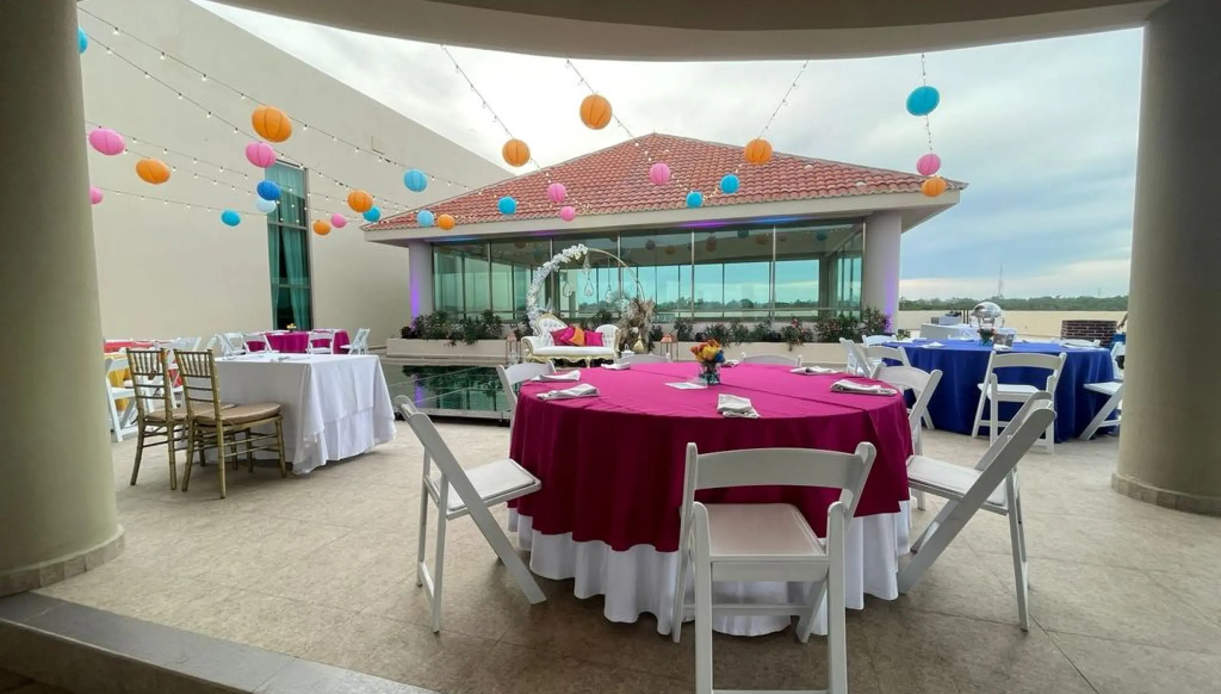 Rooftop wedding reception with pink linens and paper lanterns at El Dorado Seaside Palms, Riviera Maya