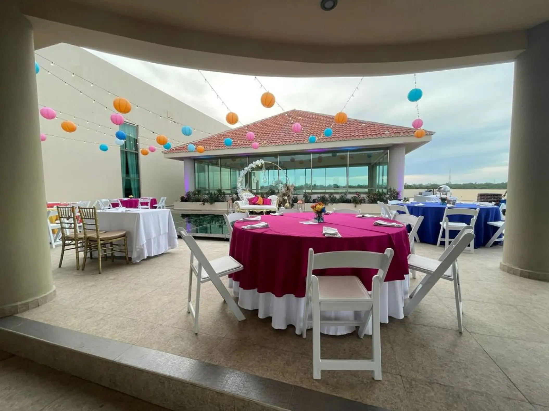 Rooftop wedding reception with pink linens and paper lanterns at El Dorado Seaside Palms, Riviera Maya