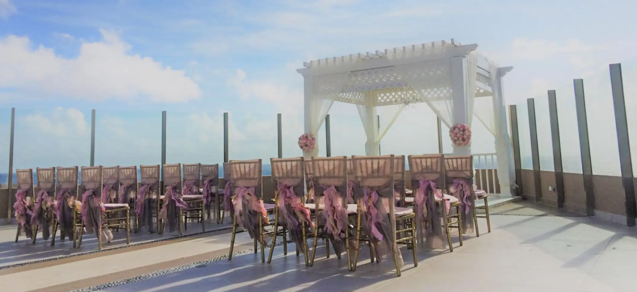 Sky Deck wedding ceremony with white gazebo and purple chair decor at El Dorado Seaside Palms, Riviera Maya