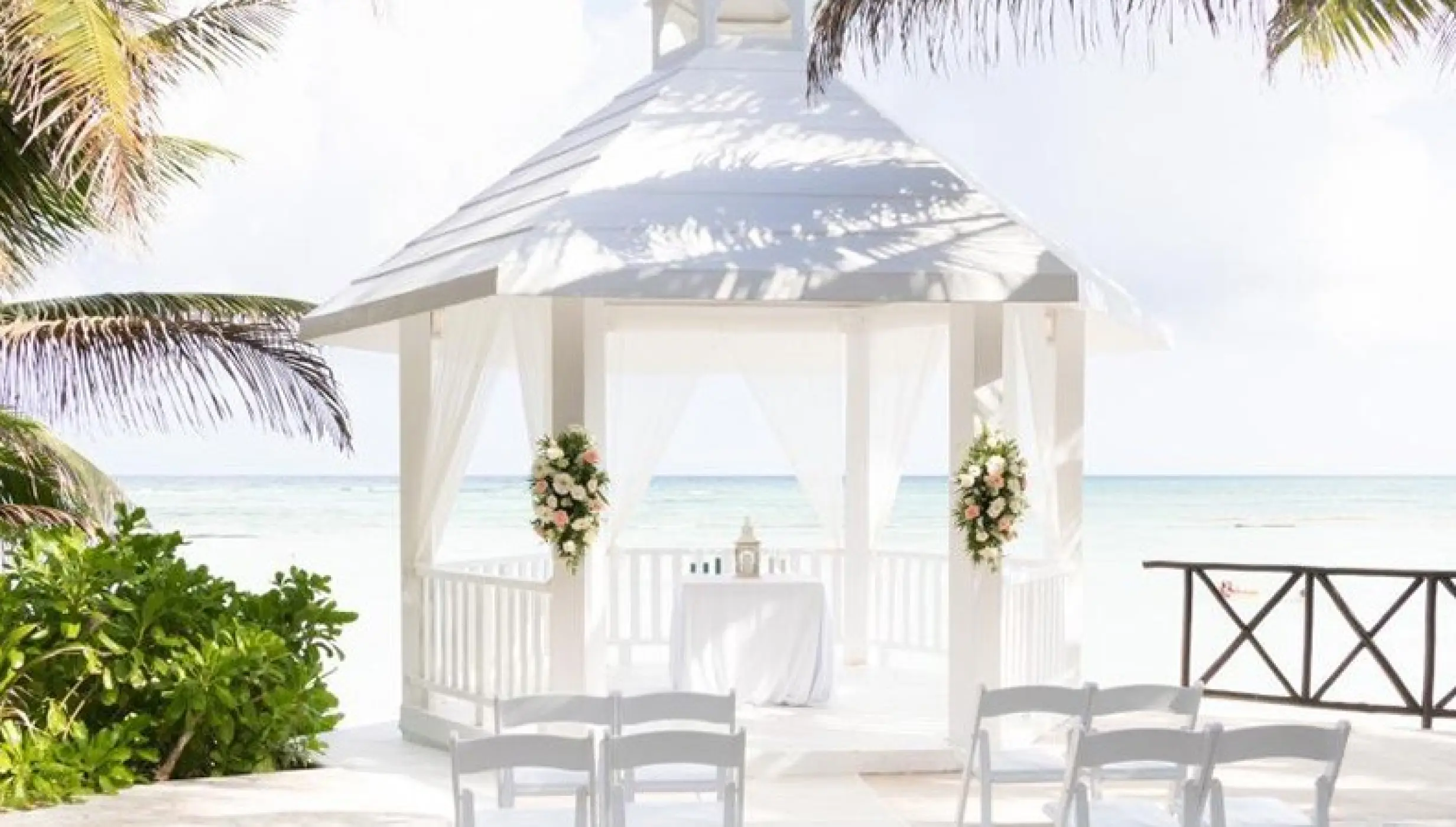 White beachfront gazebo wedding ceremony at El Dorado Seaside Palms, Riviera Maya