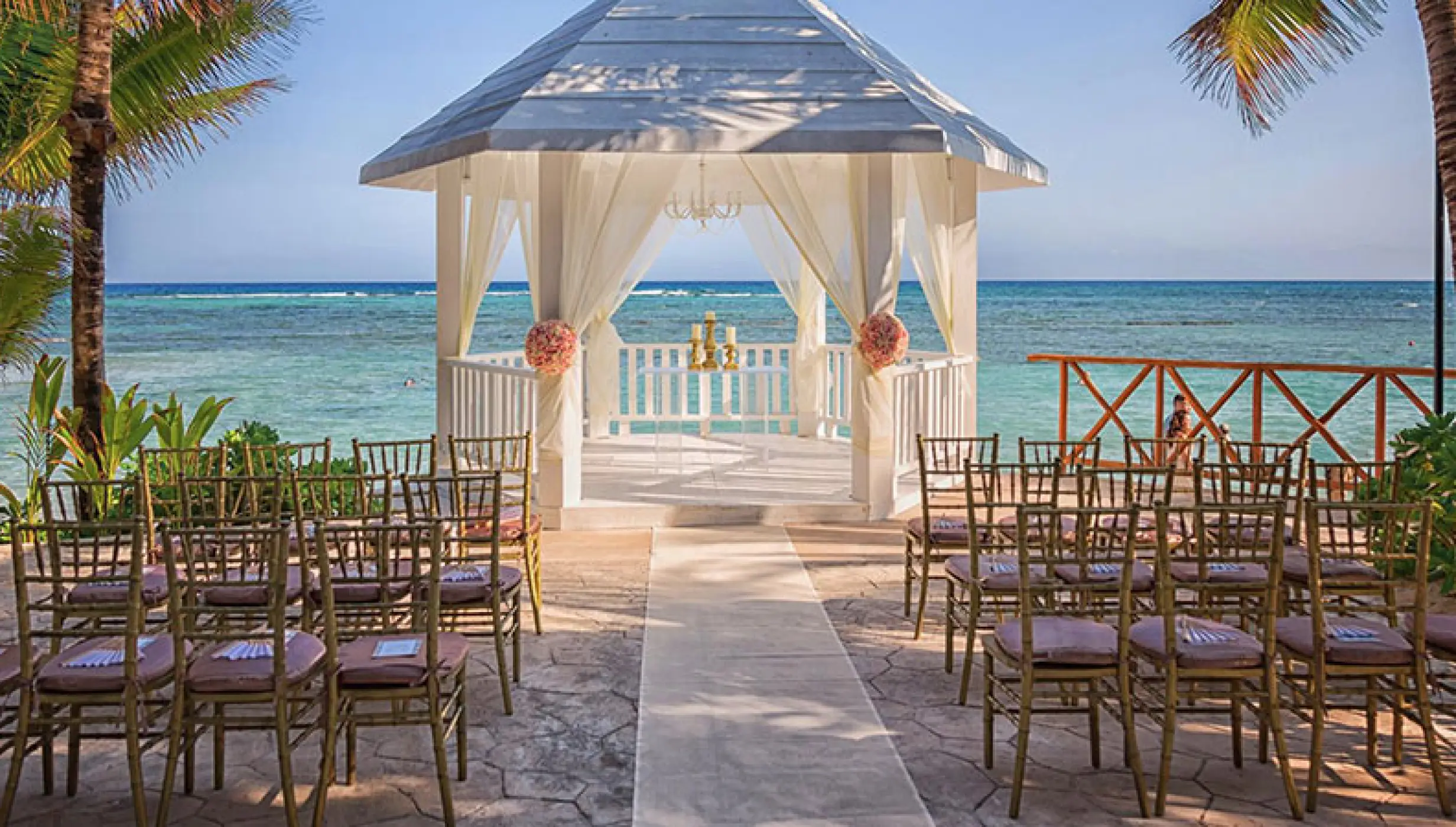 White gazebo wedding ceremony at El Dorado Seaside Palms, Riviera Maya