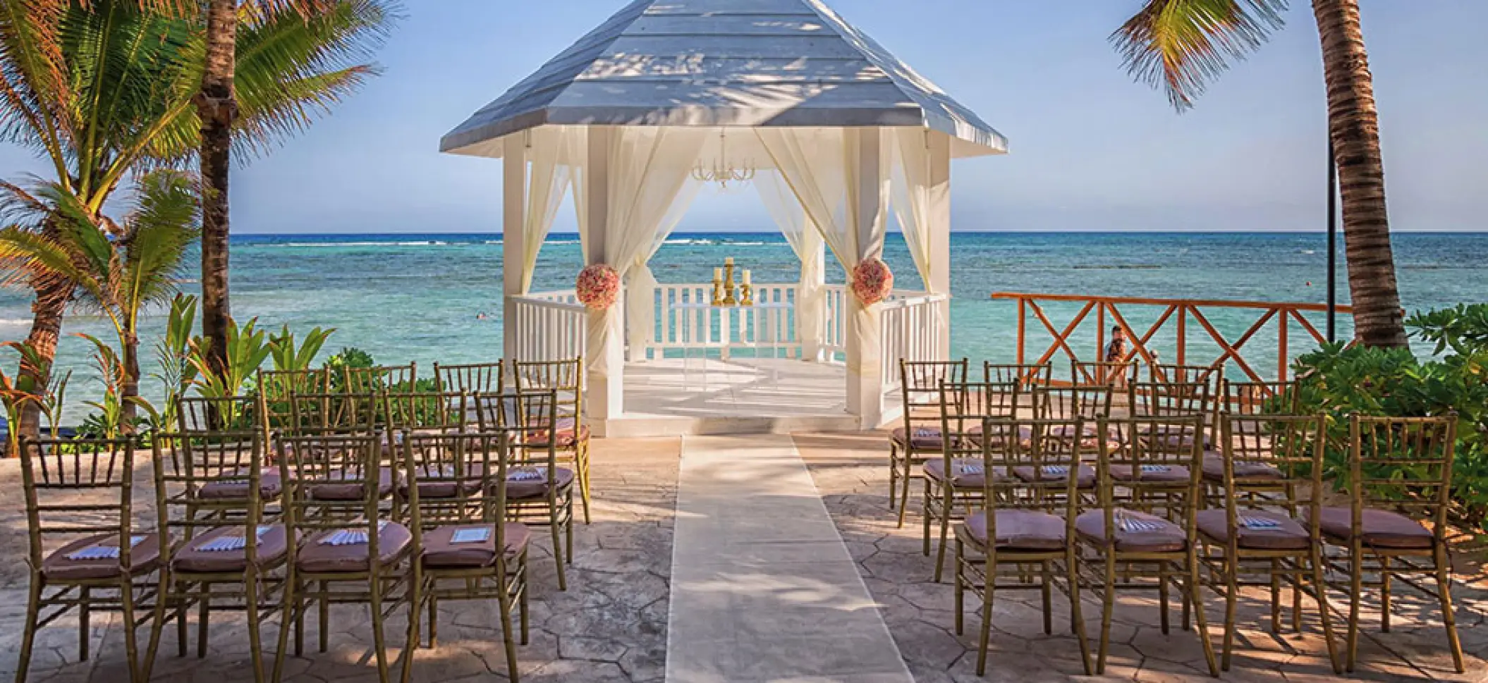 White gazebo wedding ceremony at El Dorado Seaside Palms, Riviera Maya