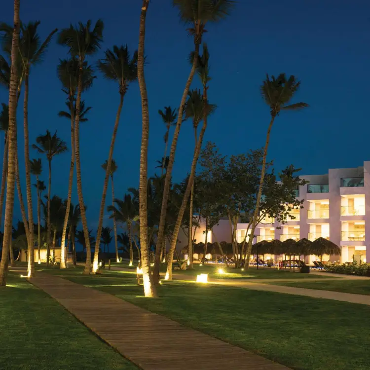 Excellence El Carmen lit pathways and modern suites at night, Punta Cana