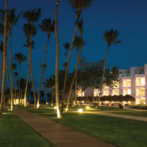 Excellence El Carmen lit pathways and modern suites at night, Punta Cana