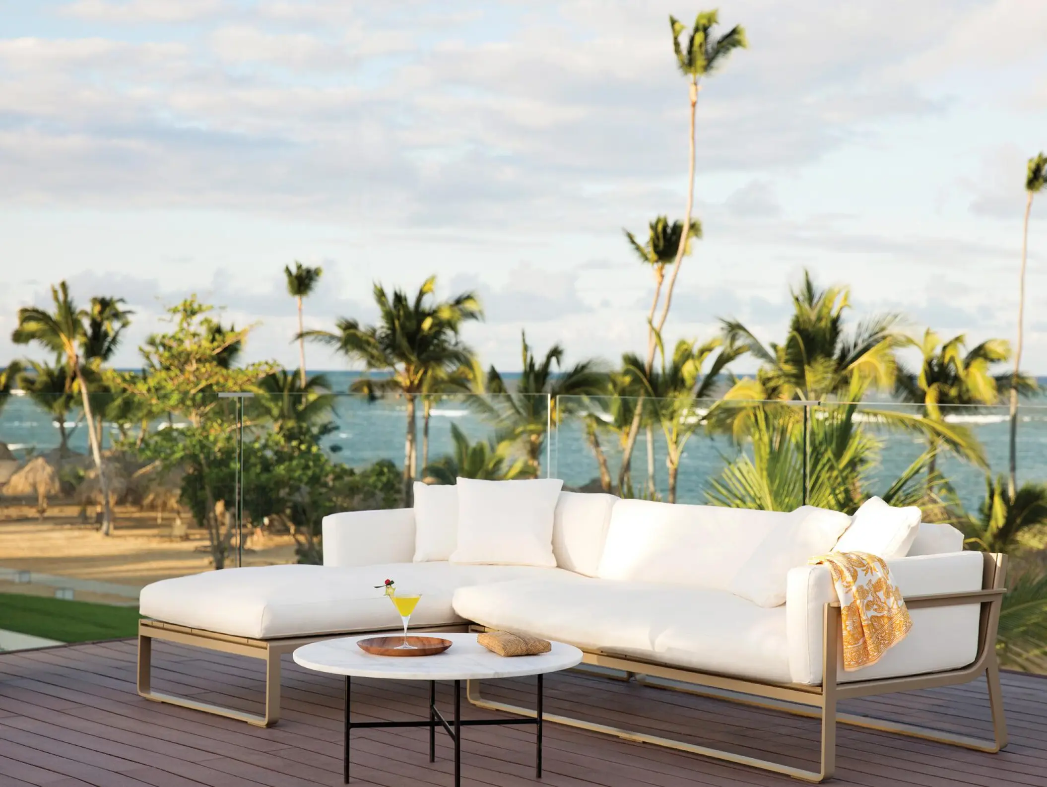 Outdoor lounge with white sofas and ocean views at Excellence El Carmen, Punta Cana