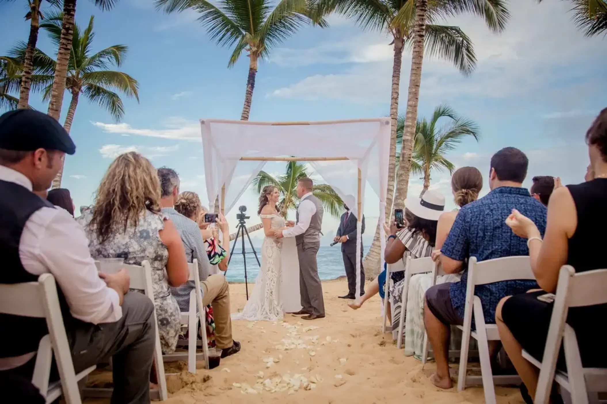 Beachfront wedding ceremony under a white canopy at Excellence El Carmen, Punta Cana