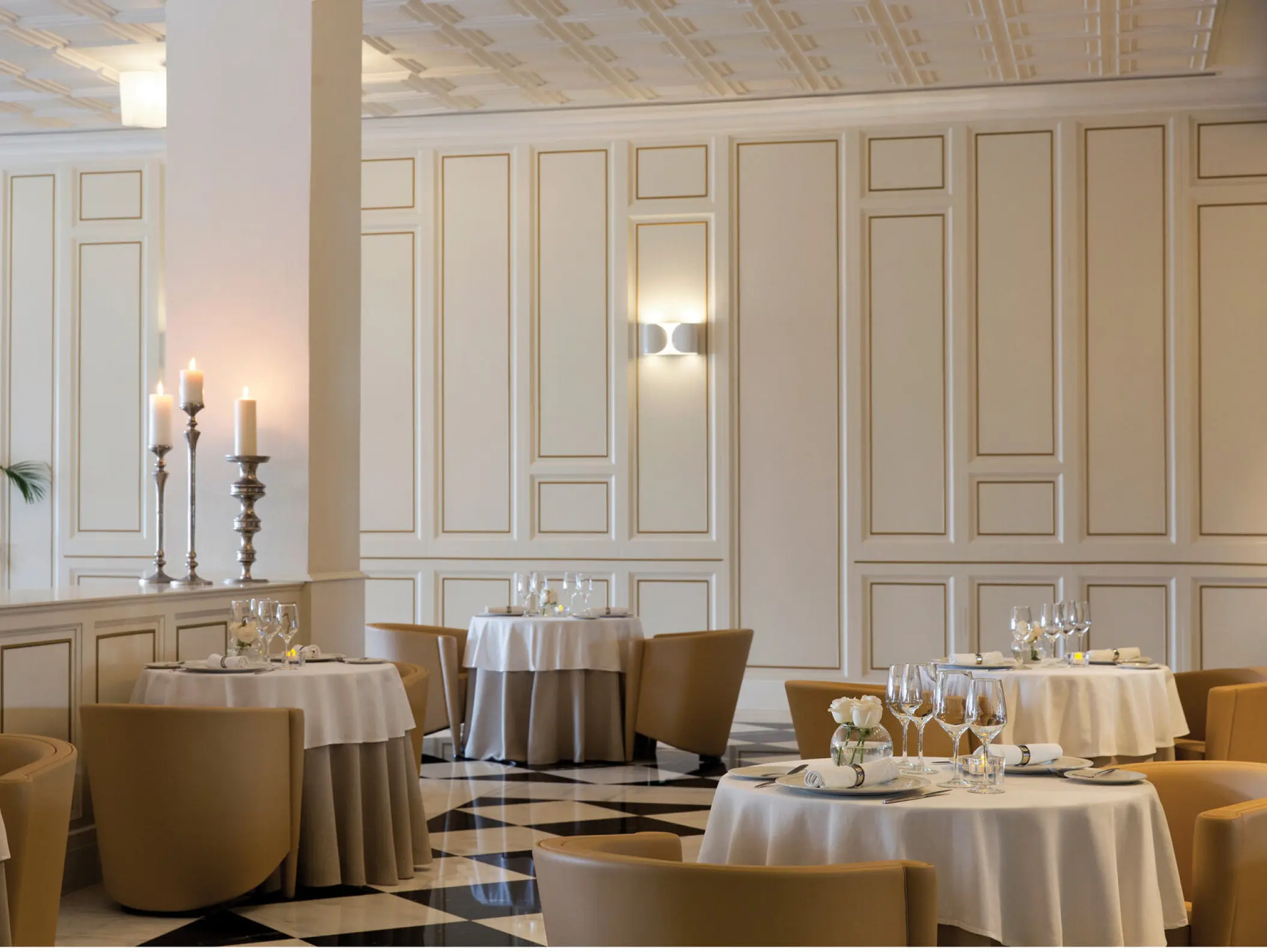 French restaurant with white paneled walls and checkered floors at Excellence El Carmen, Punta Cana