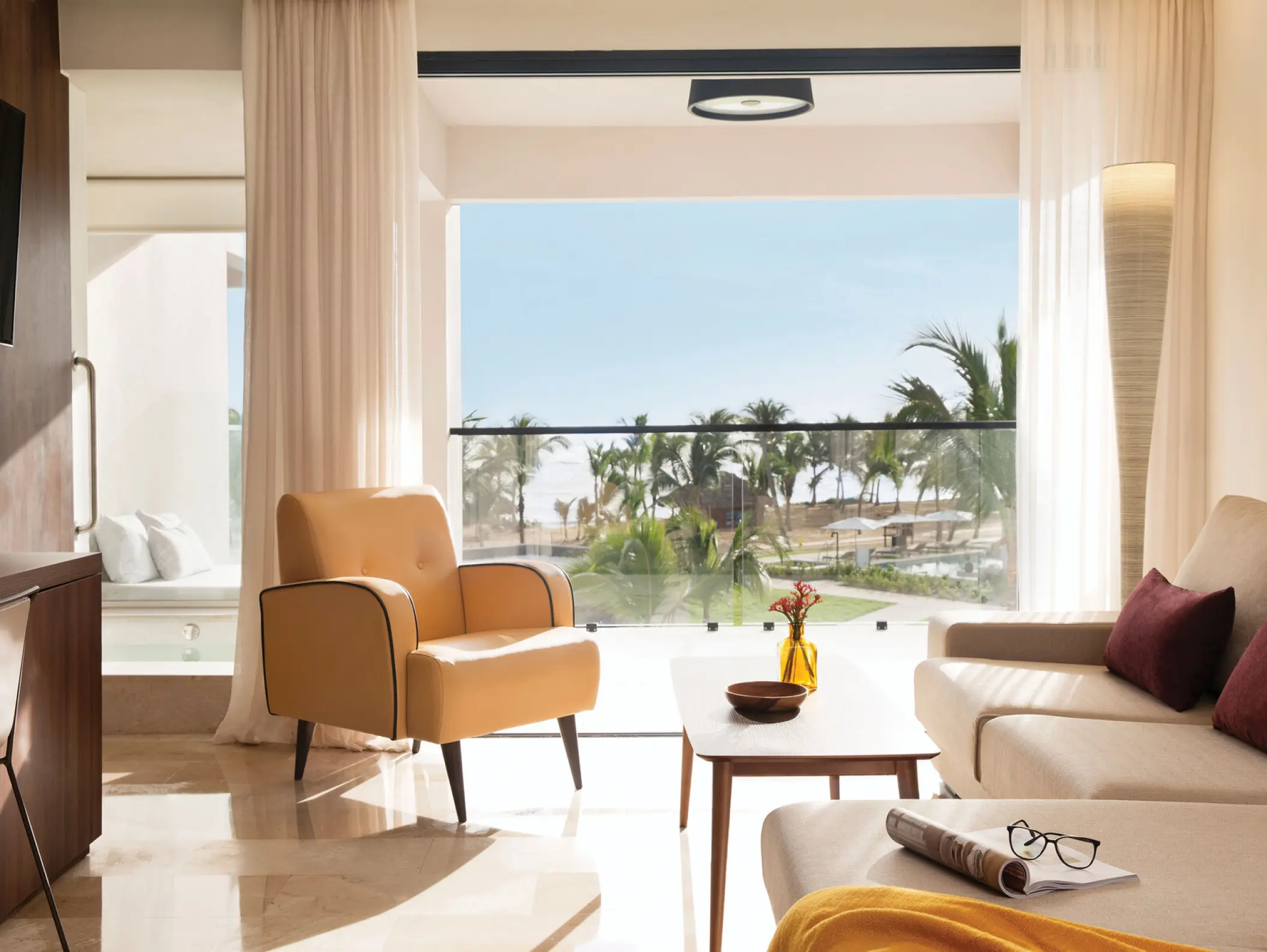 Luxury suite living area with balcony view at Excellence El Carmen, Punta Cana