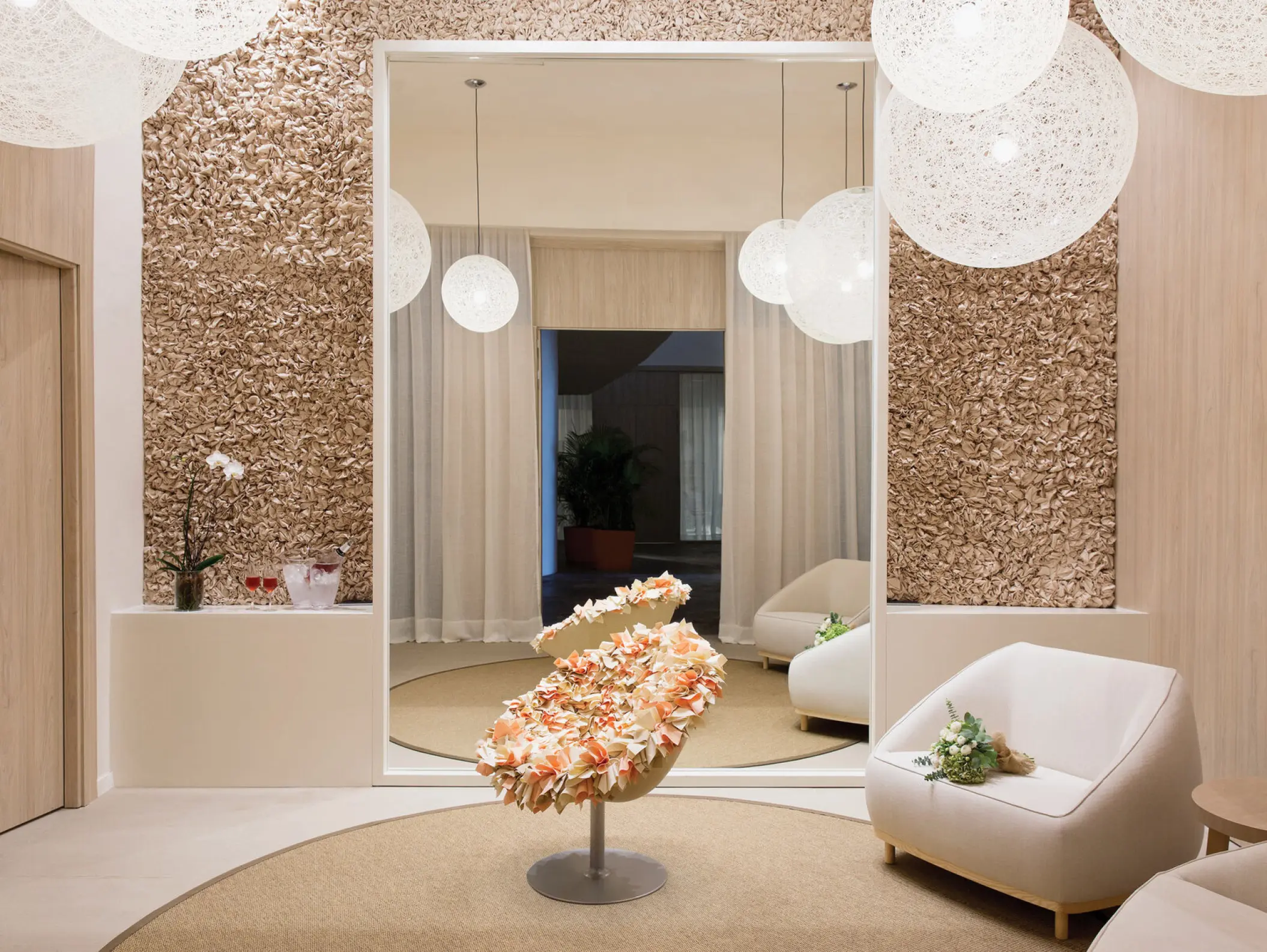 Modern spa lounge with textured gold walls and orb lighting at Excellence El Carmen, Punta Cana