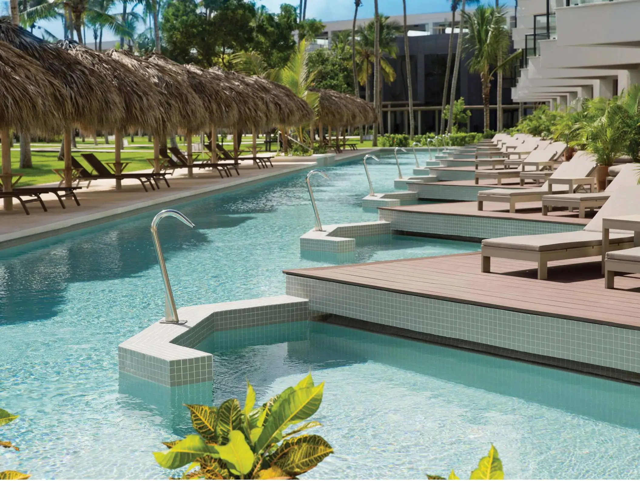 Swim-up suites and outdoor pool with sun loungers at Excellence El Carmen, Punta Cana