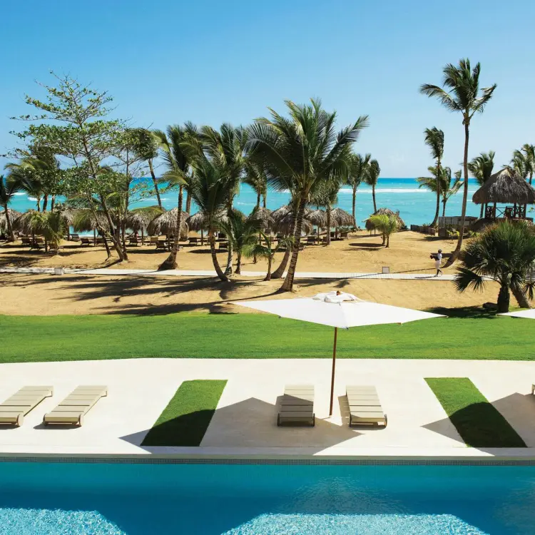 Swim-up pool and lounge deck overlooking the beach at Excellence El Carmen, Punta Cana