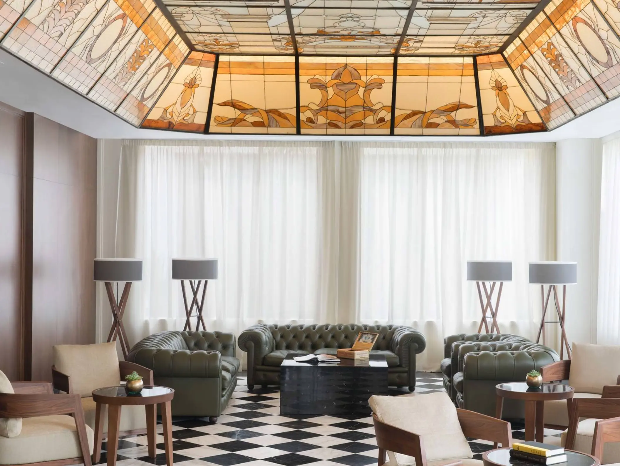 Stained glass ceiling and leather seating at the Excellence Playa Mujeres cigar bar, Cancun