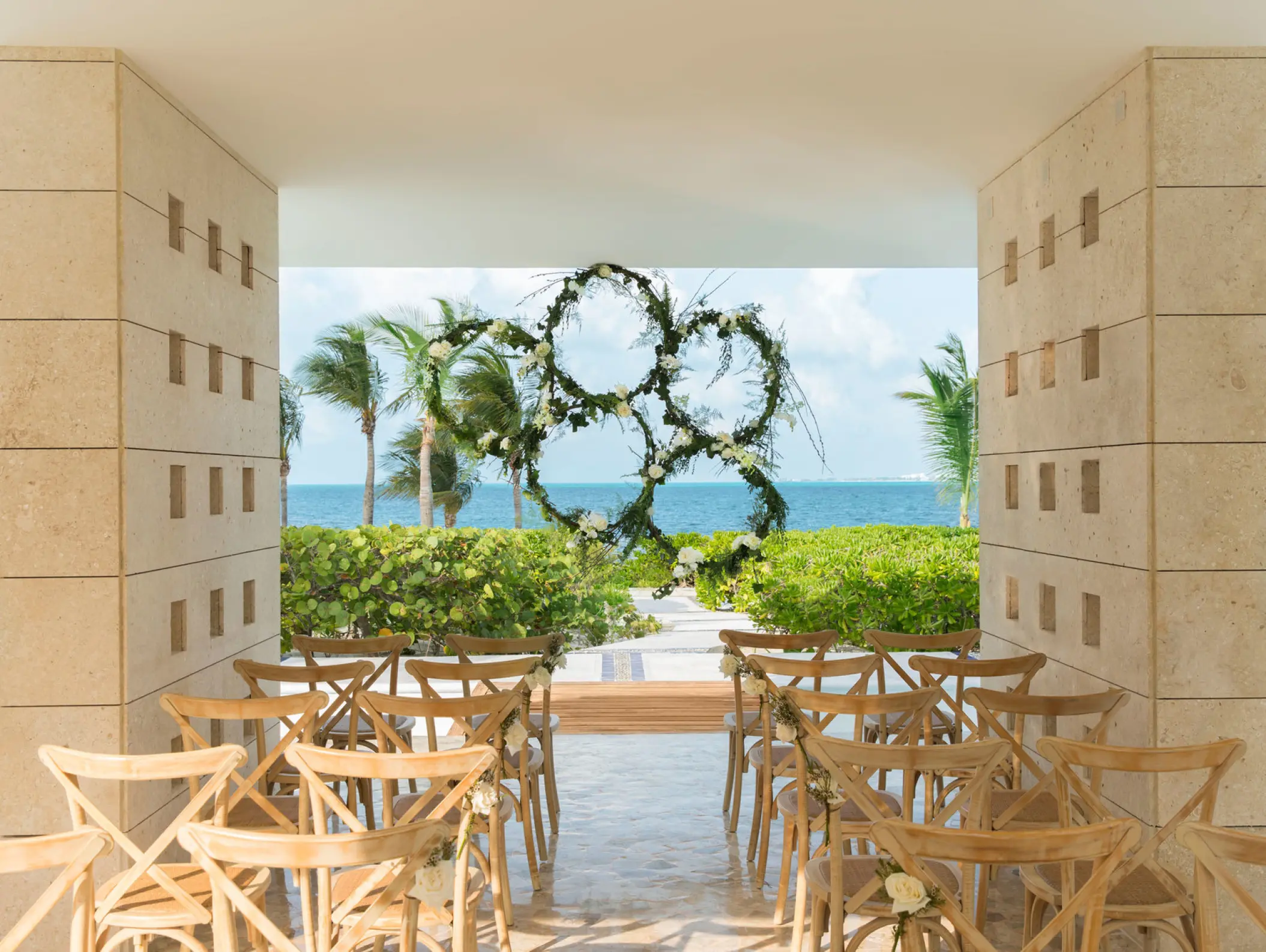 Floral ring wedding ceremony arch at Excellence Playa Mujeres, Cancun