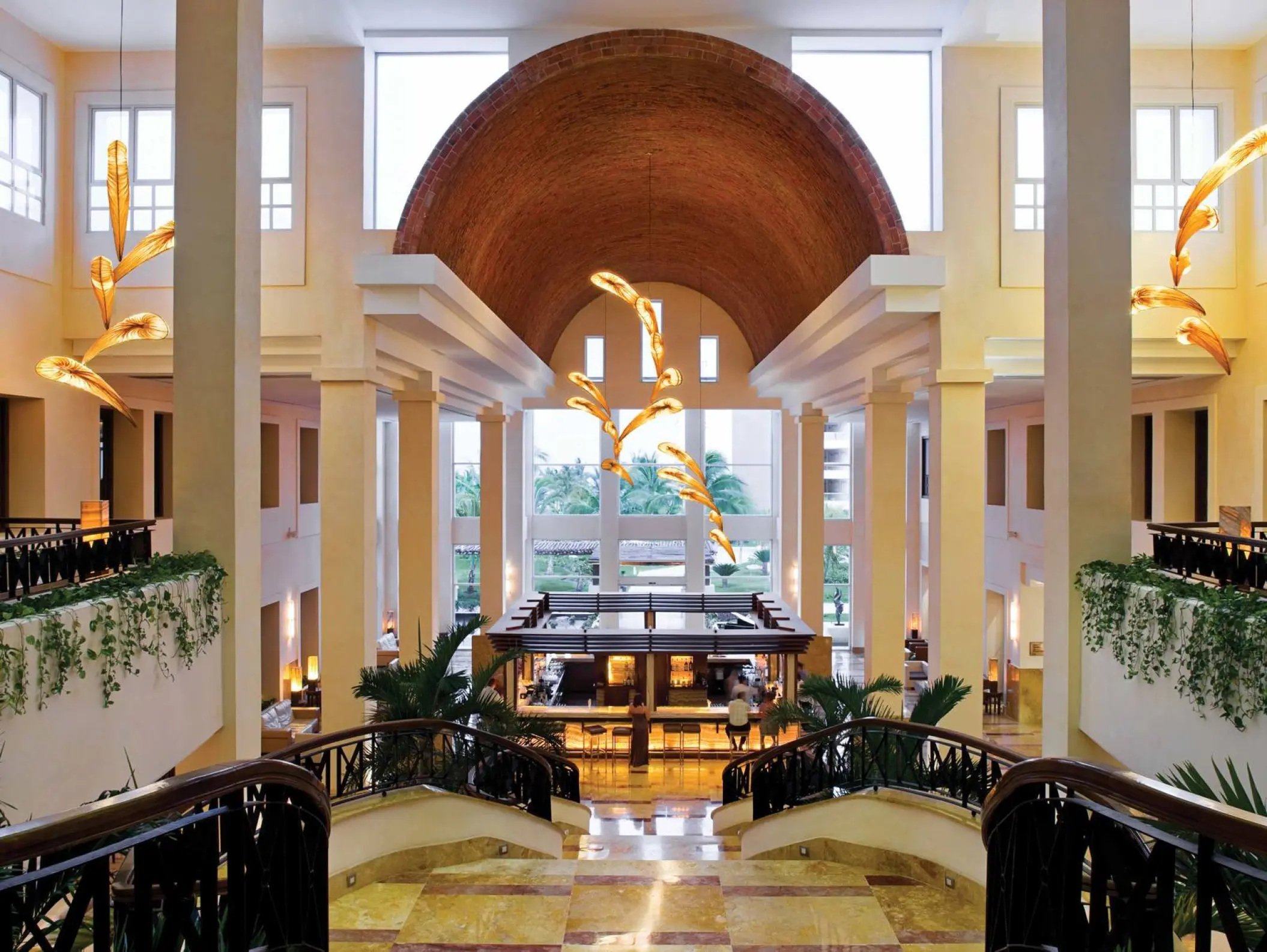 Excellence Playa Mujeres lobby bar with vaulted brick ceiling and modern light fixtures, Cancun