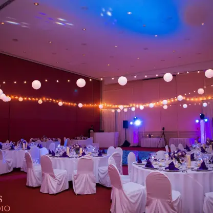 Indoor wedding reception with string lights and round tables at Excellence Riviera Cancun, Riviera Maya