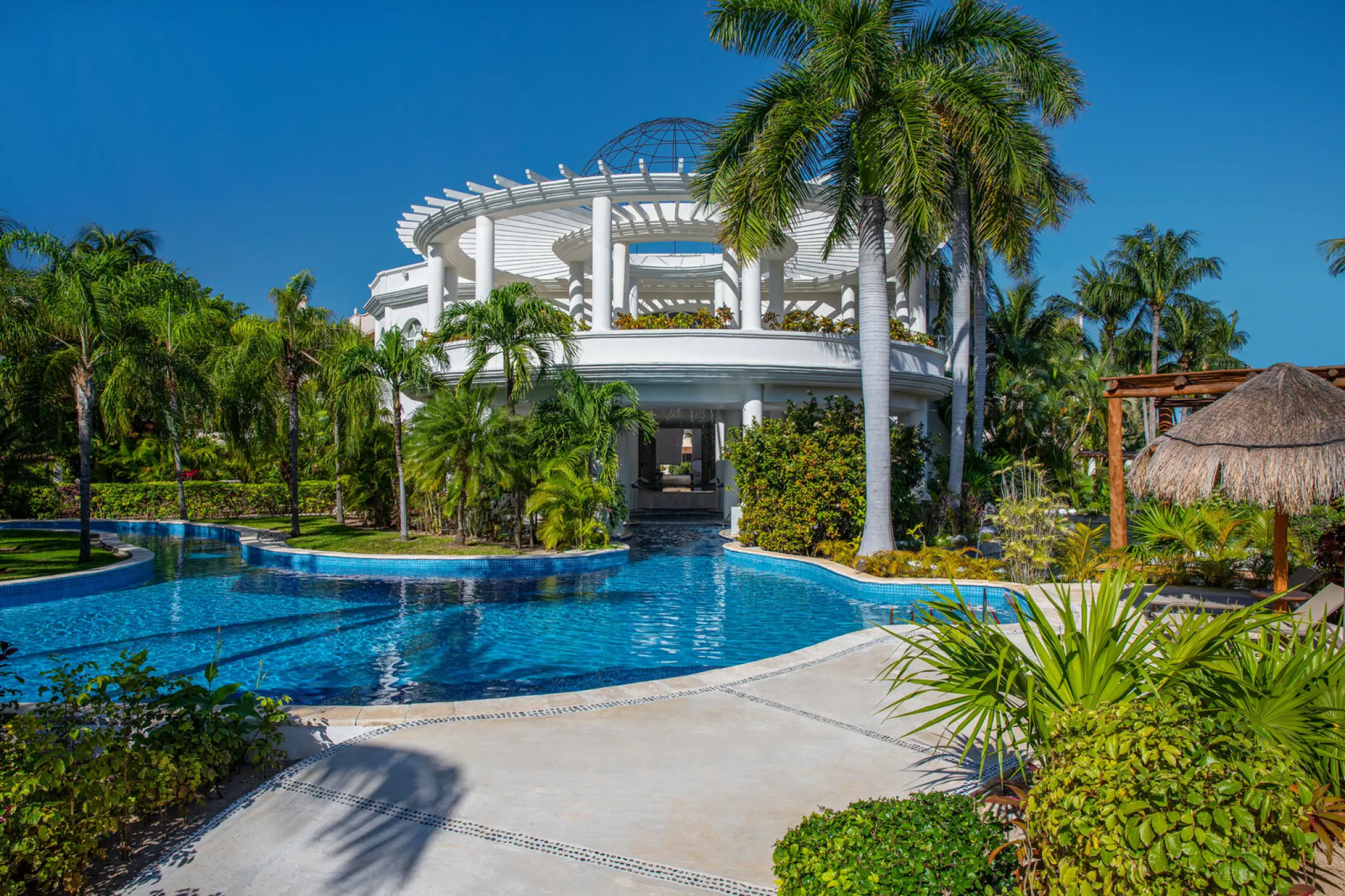 White circular gazebo and winding swimming pool at Excellence Riviera Cancun, Riviera Maya