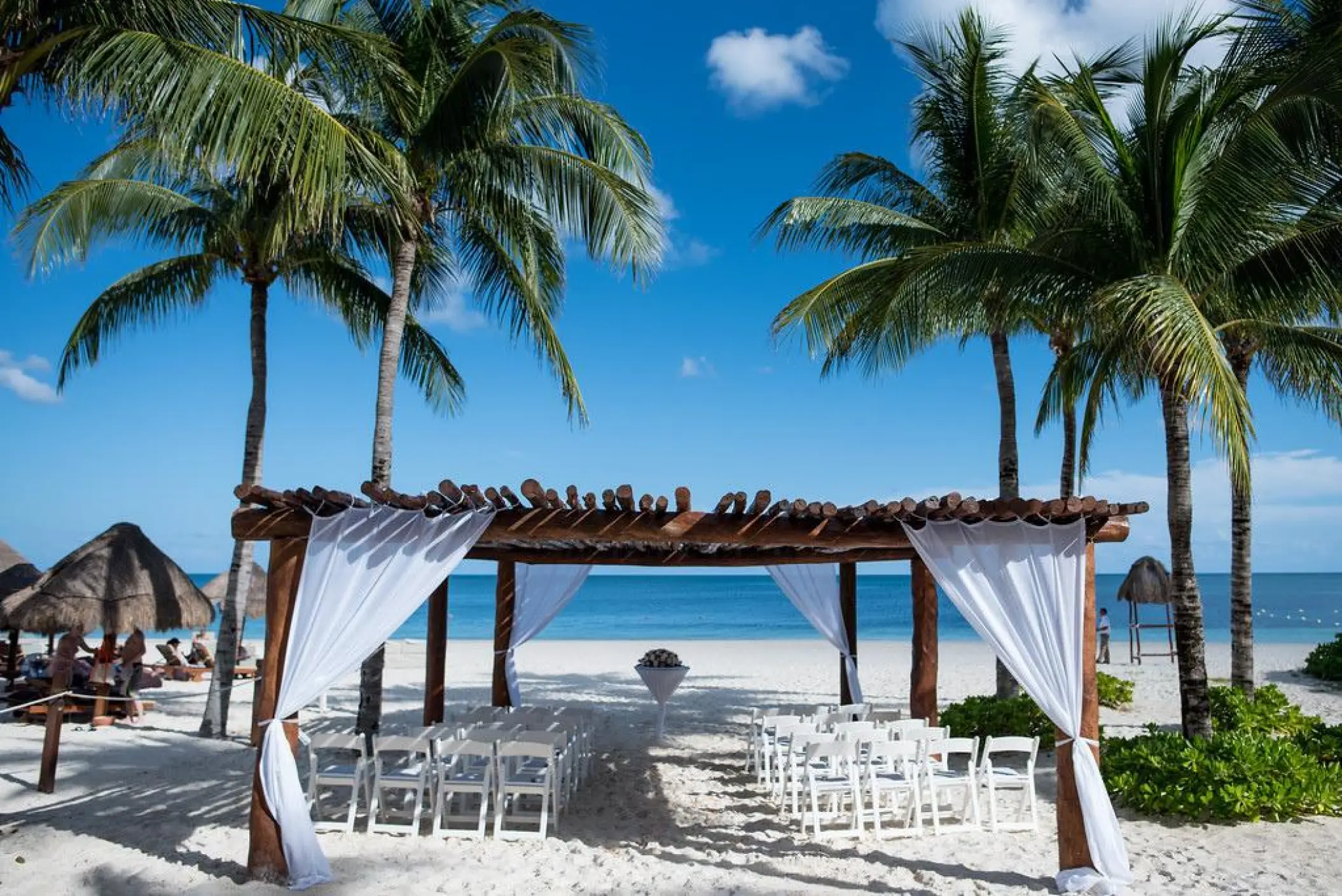Beachfront wedding ceremony setup under a wooden gazebo at Excellence Riviera Cancun, Riviera Maya