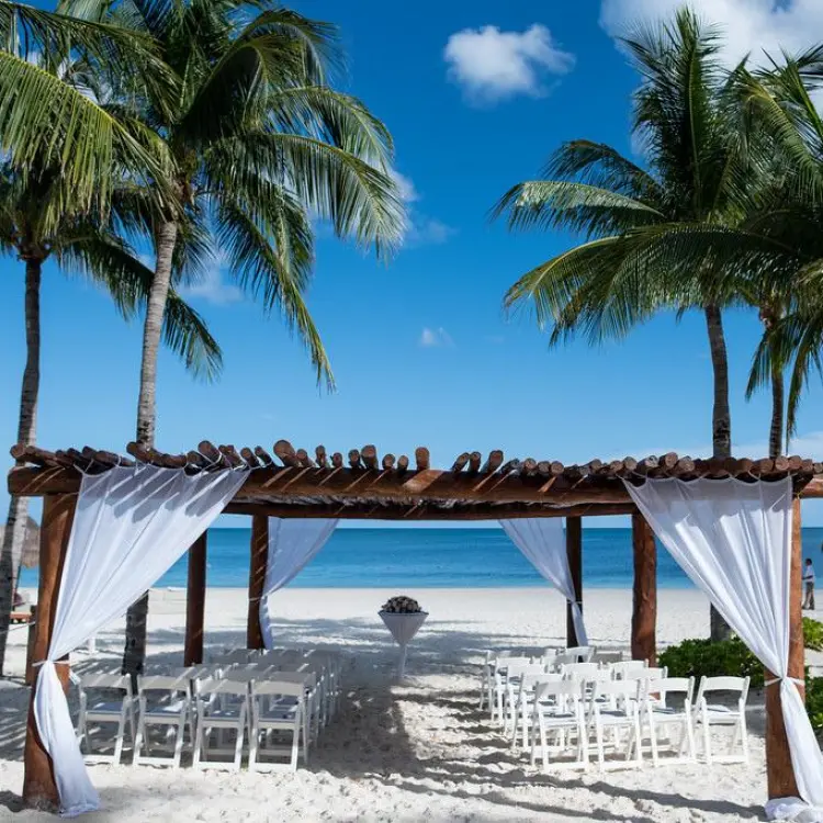 Beachfront wedding ceremony setup under a wooden gazebo at Excellence Riviera Cancun, Riviera Maya
