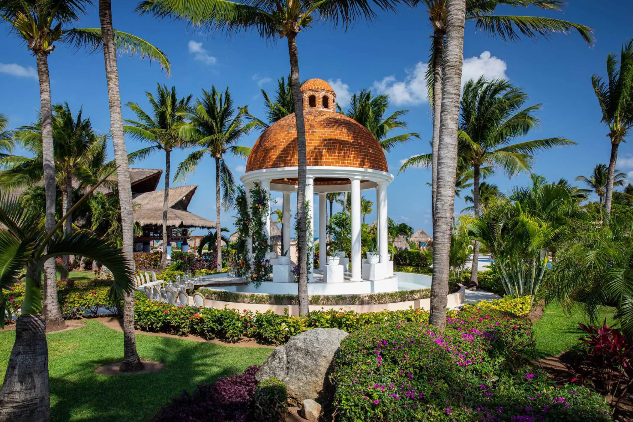 Stone wedding gazebo with a terracotta dome at Excellence Riviera Cancun, Riviera Maya