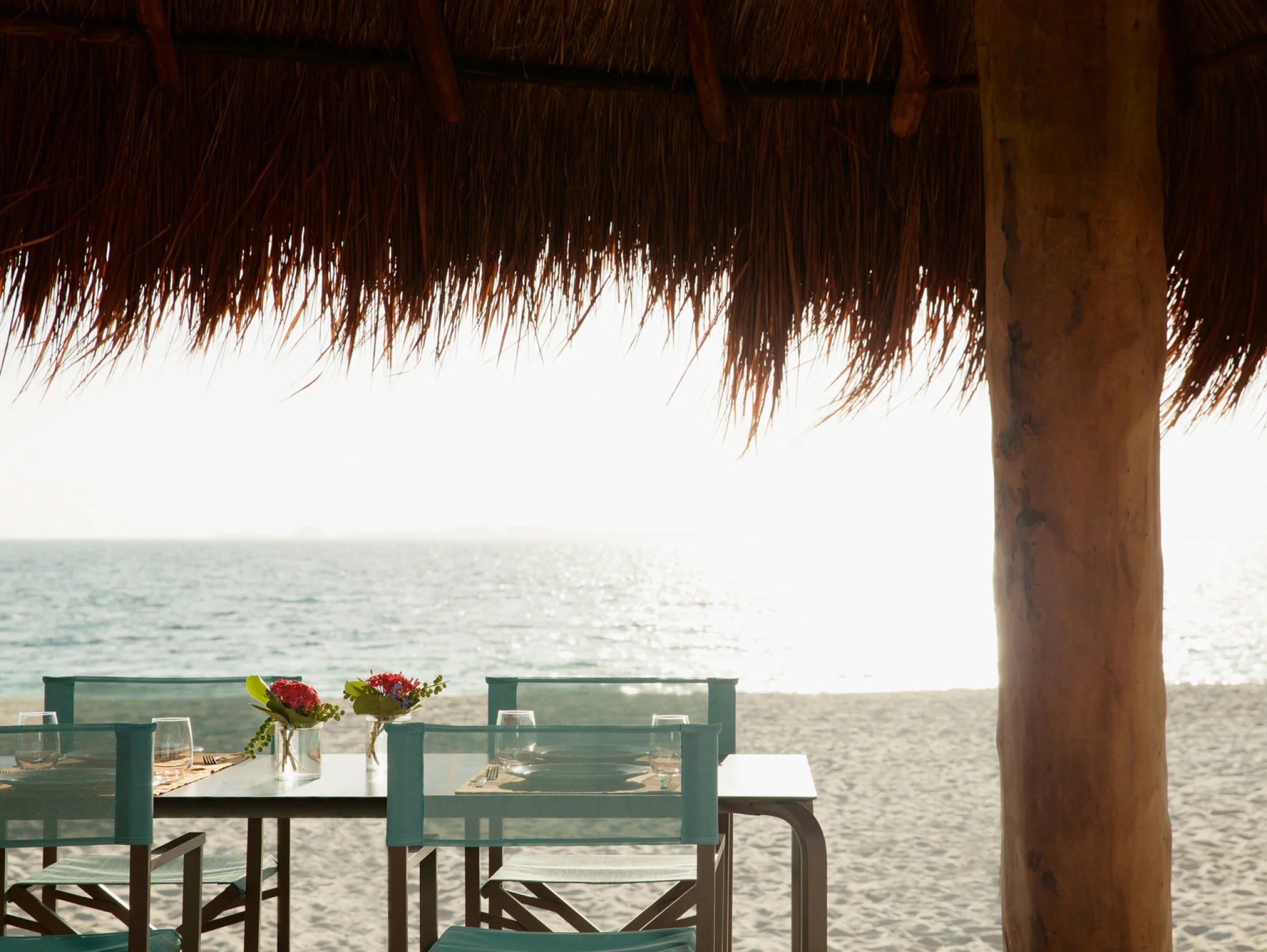 Finest Playa Mujeres table under palapa on beach