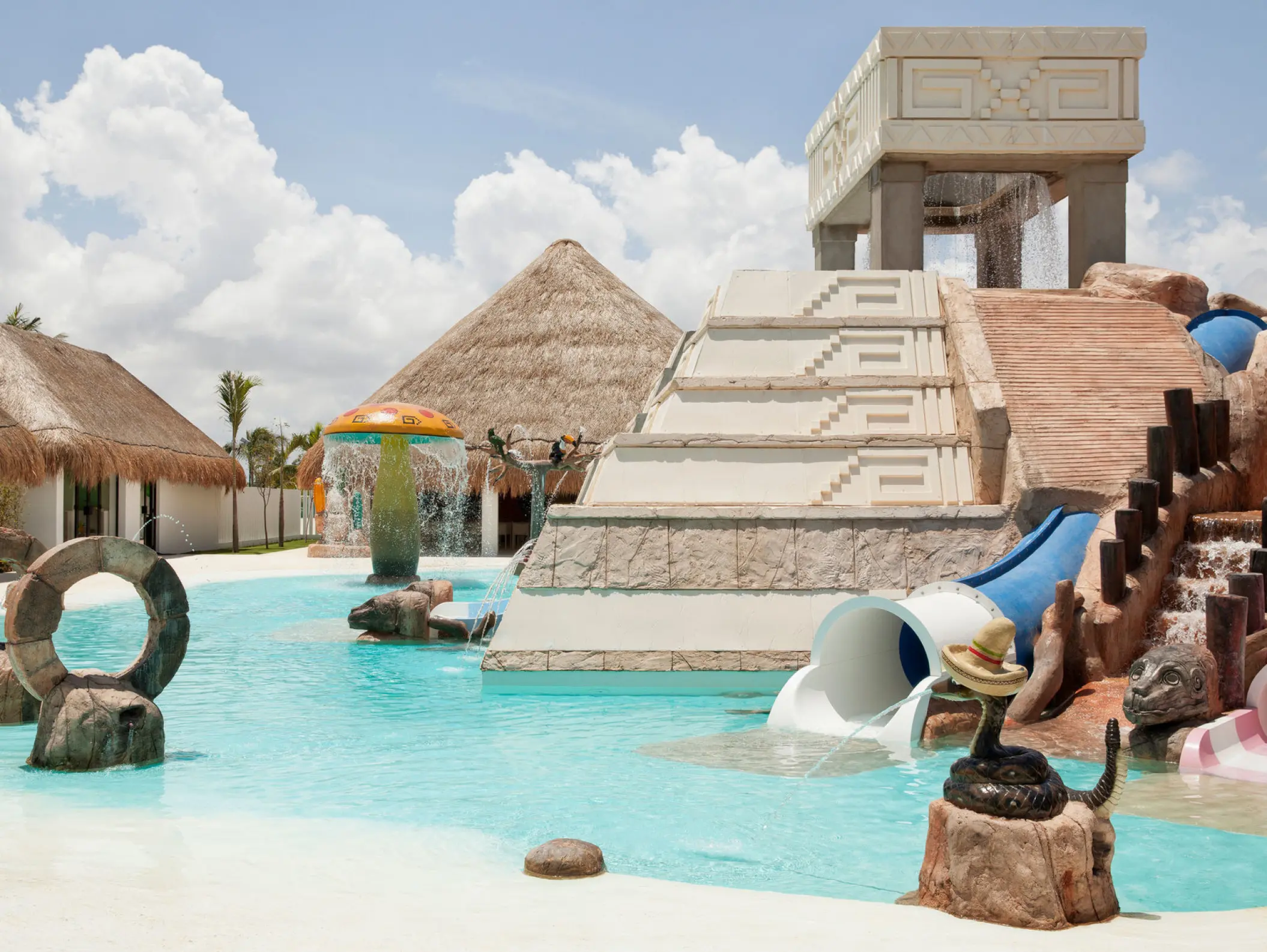 Kids water park with slides and Mayan-themed structures at Finest Playa Mujeres, Cancun
