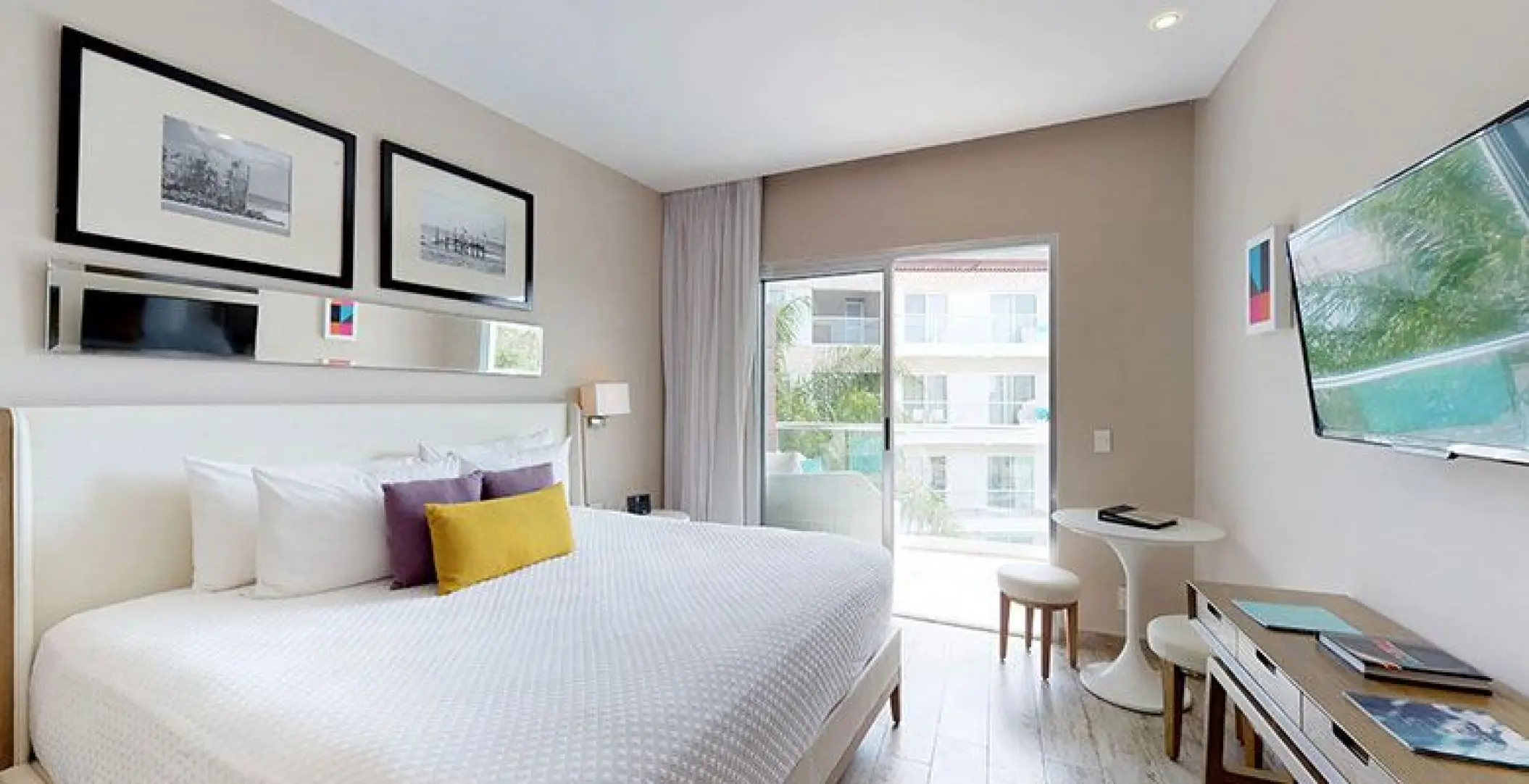 Modern bedroom with balcony access at The Fives Beach Hotel, Playa Del Carmen