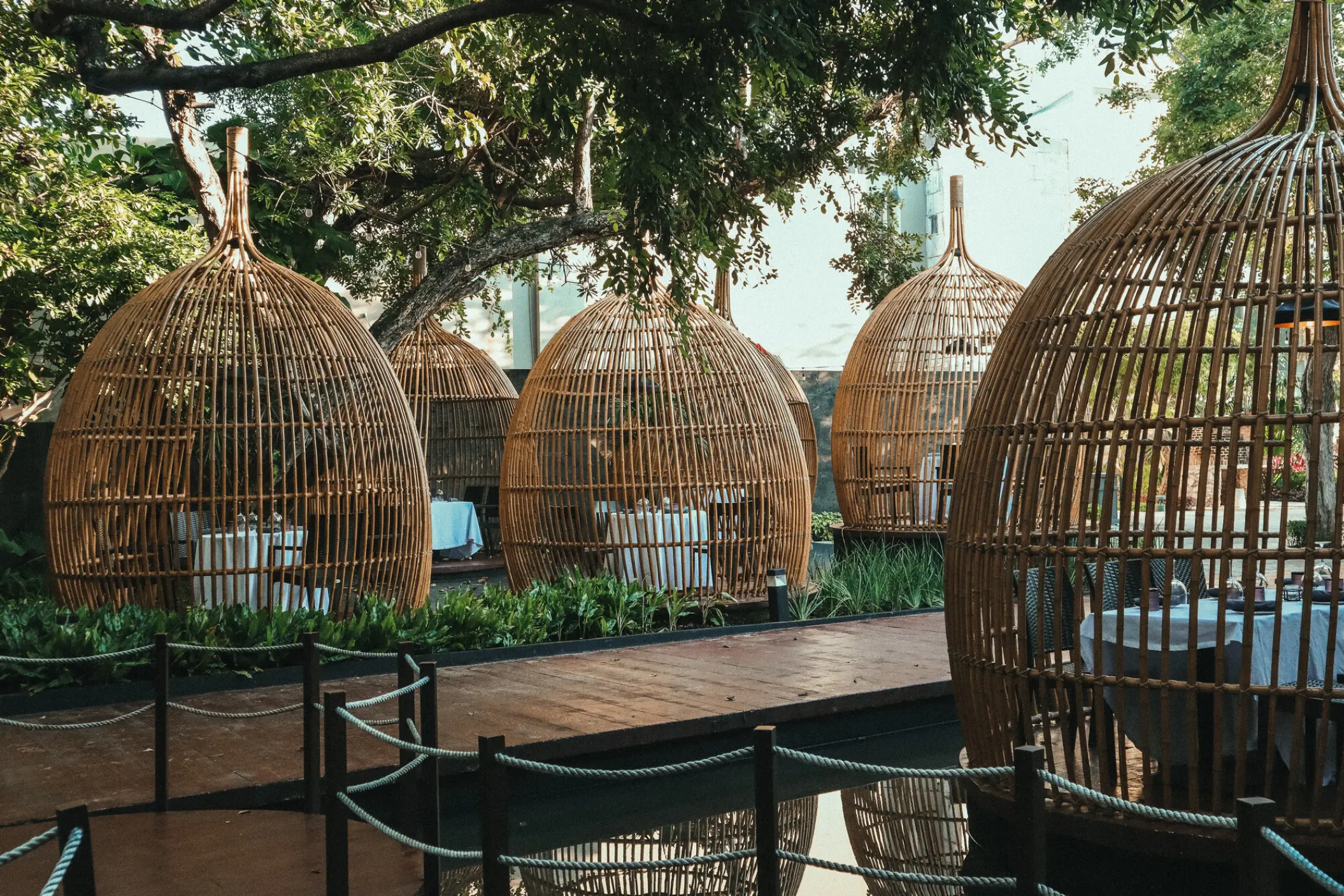 Private dining birdcage structures for a welcome dinner at The Fives Beach Hotel, Playa Del Carmen