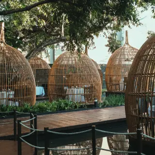 Private dining birdcage structures for a welcome dinner at The Fives Beach Hotel, Playa Del Carmen