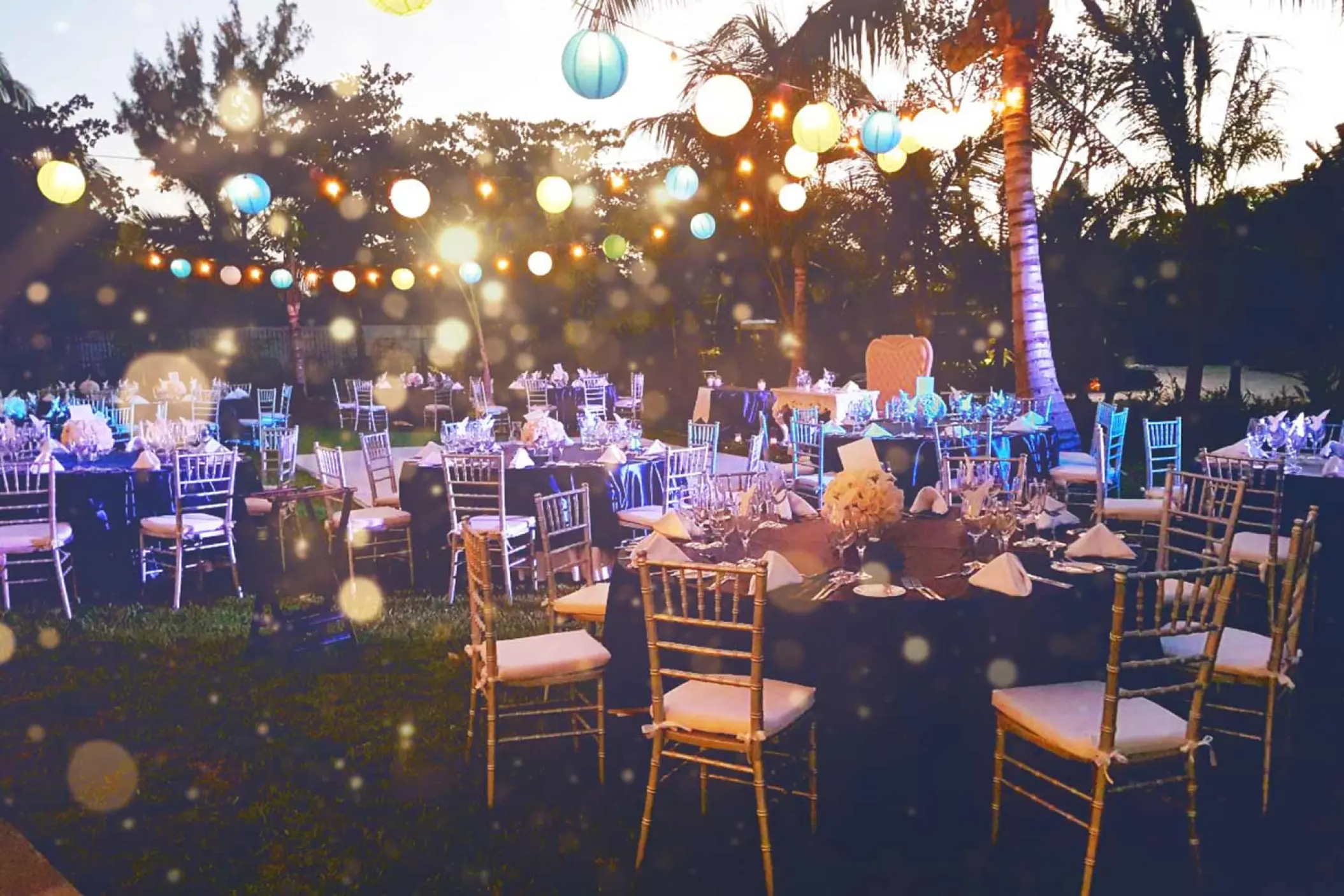Evening wedding reception at The Fives Beach Hotel, Playa Del Carmen with lantern lights over garden tables