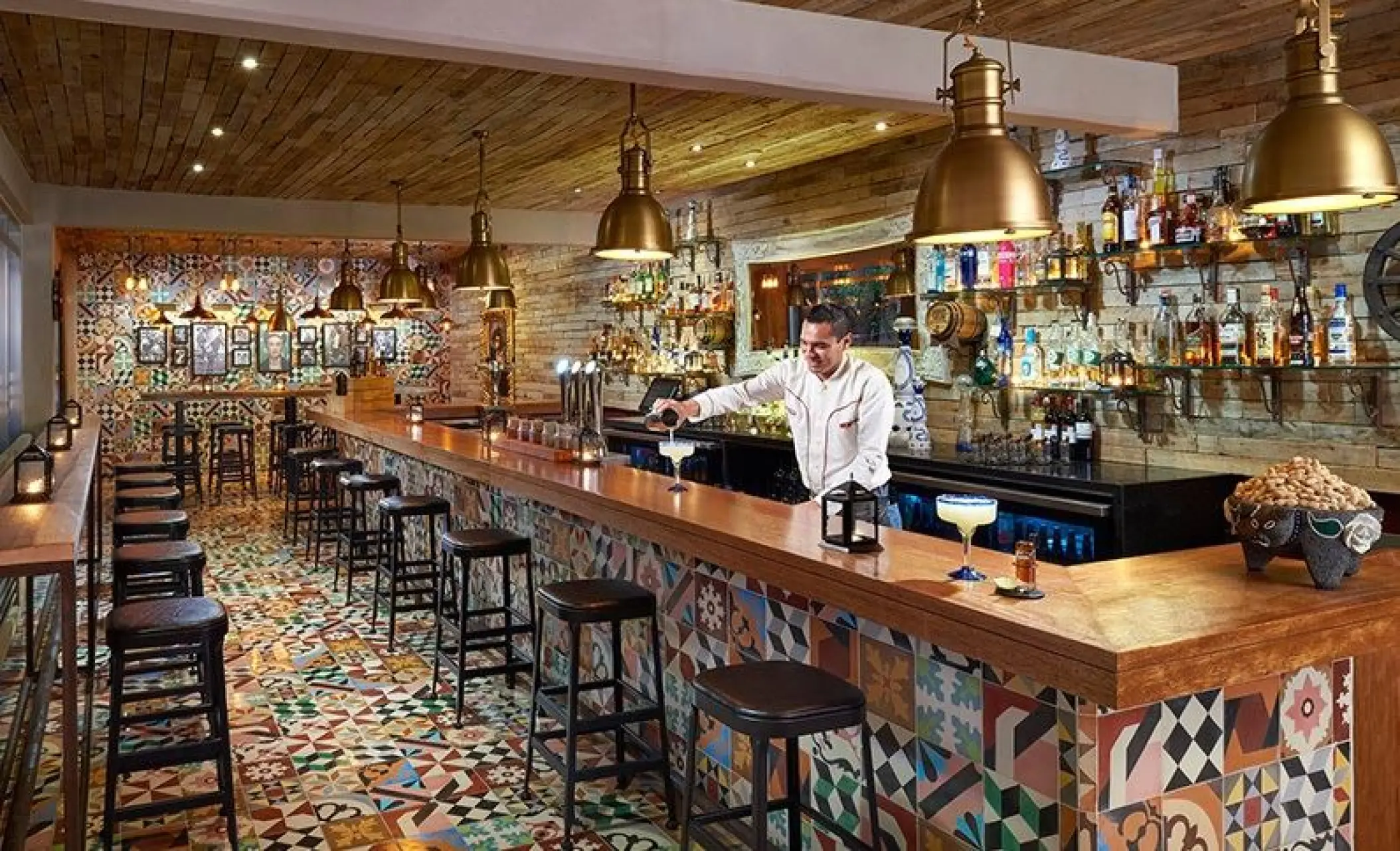Bartender preparing drinks at the Cantina 1910 bar in The Fives Beach, Playa Del Carmen