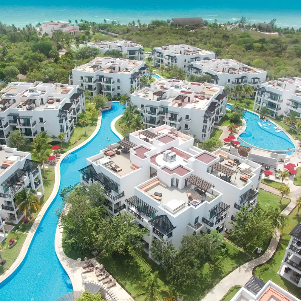 Aerial view of pools and white modern buildings at The Fives Beach Hotel, Playa Del Carmen