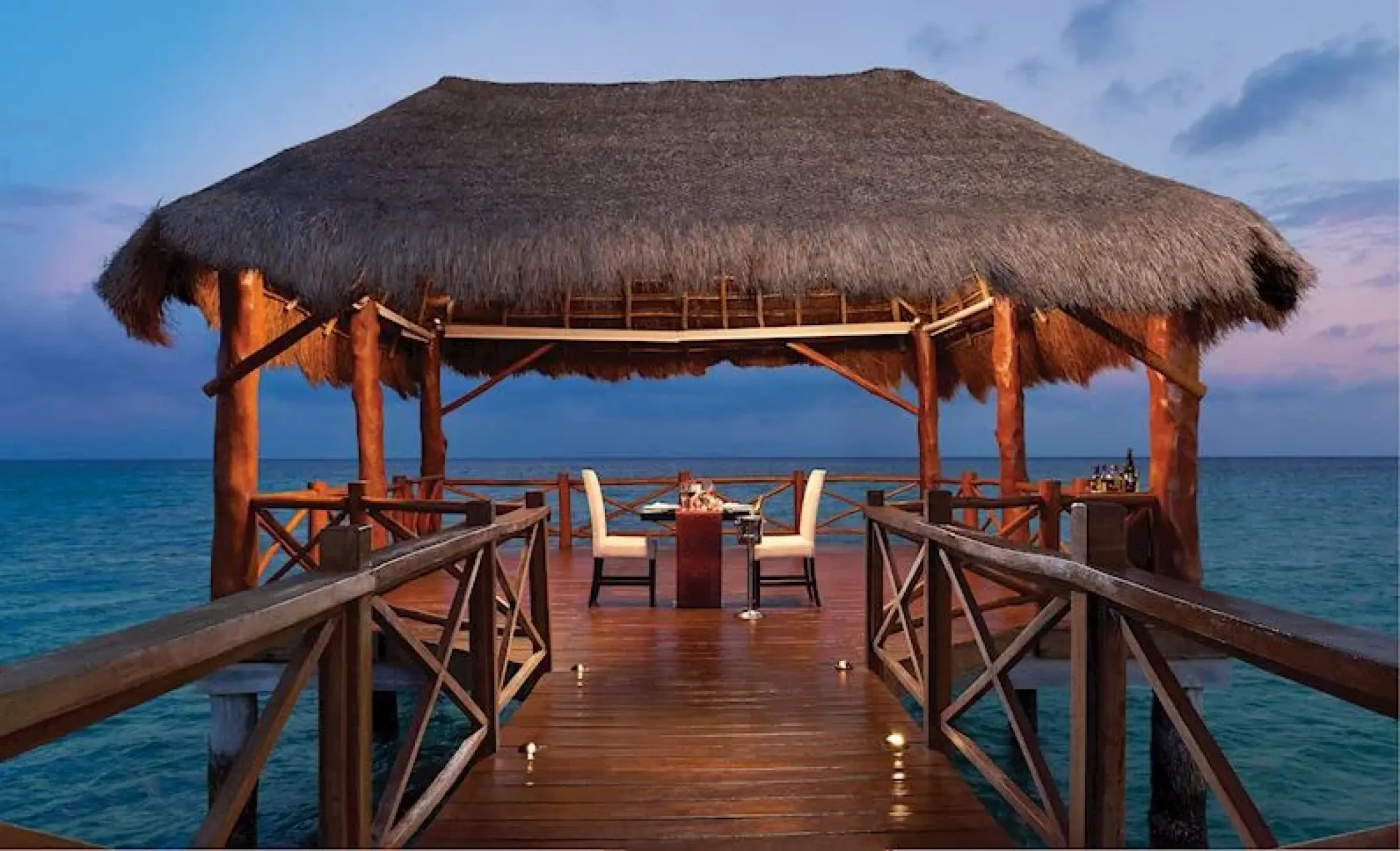 Private romantic dinner setup on a pier gazebo at The Fives Beach Hotel, Playa Del Carmen