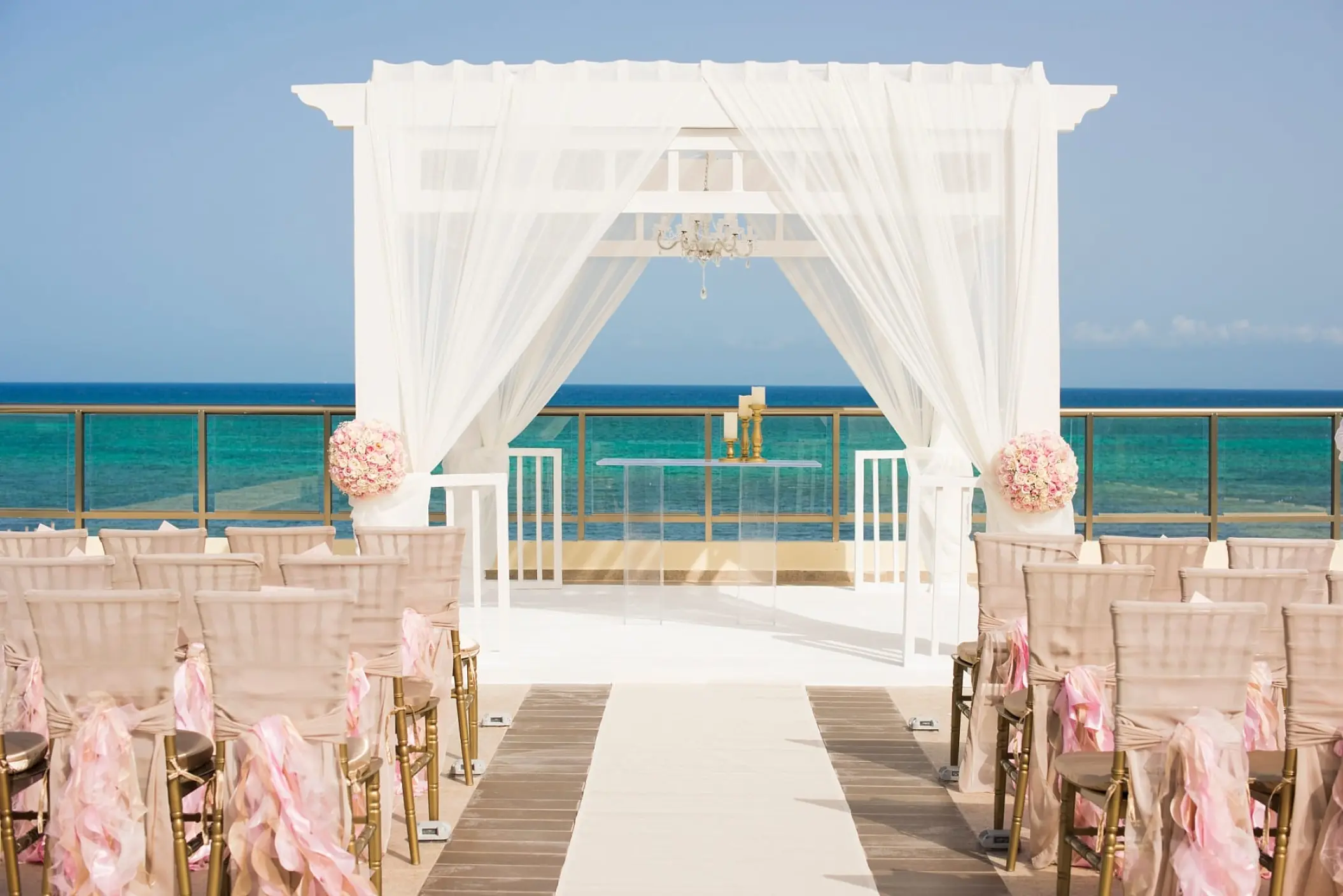 Rooftop wedding ceremony setup with white pergola and ocean views at The Fives Beach, Playa Del Carmen