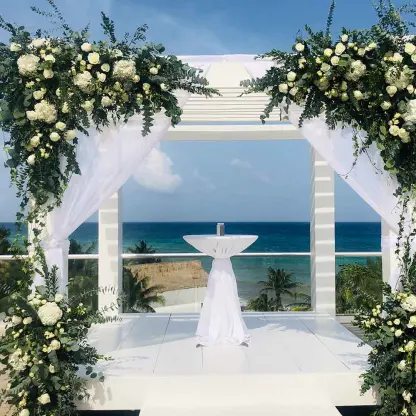 Sky deck wedding ceremony setup with white floral arch at The Fives Beach Hotel, Playa Del Carmen