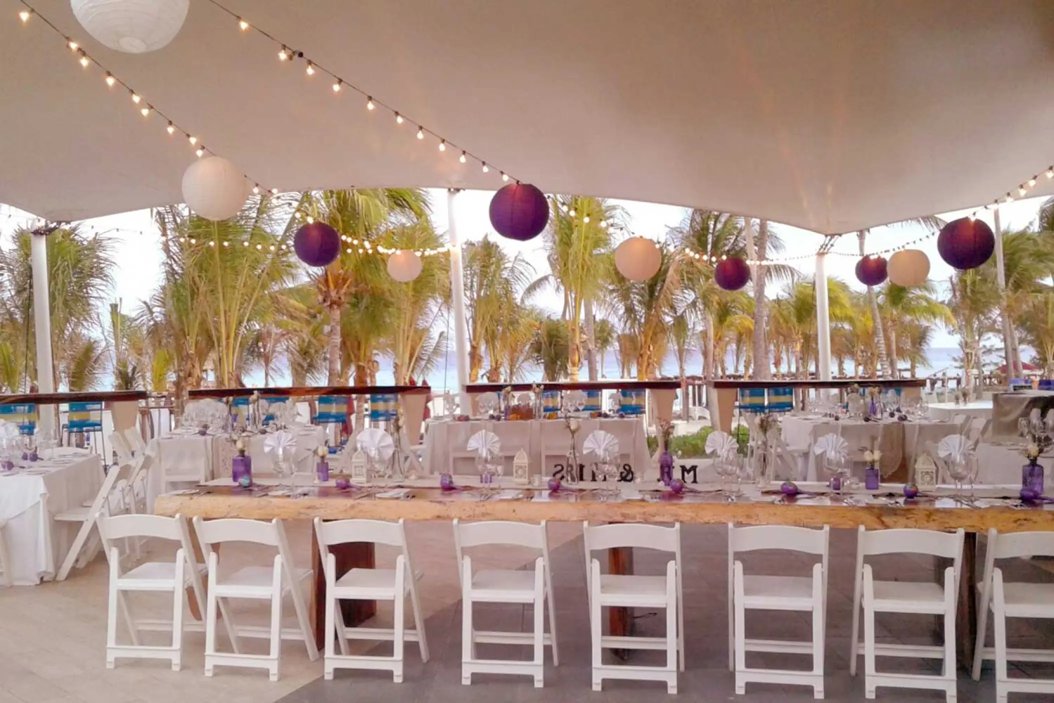 Terrace wedding reception with purple lanterns and string lights at The Fives Beach Hotel, Playa Del Carmen