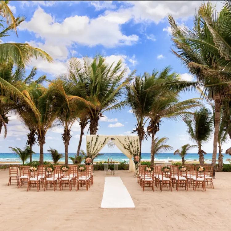 Beachfront wedding ceremony setup at El Dorado Casitas Royale, Riviera Maya
