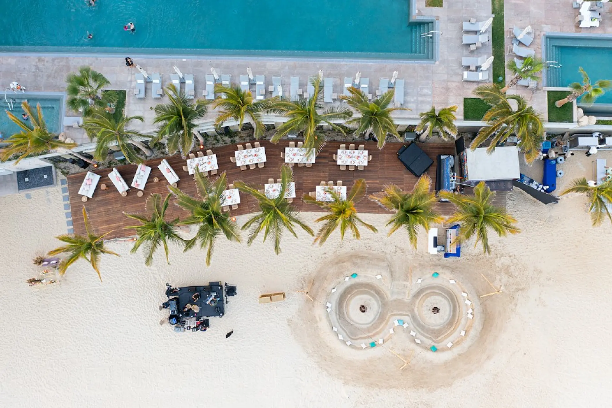 Aerial view of a beachfront wedding reception and fire pit at Garza Blanca Los Cabos, Cabo San Lucas