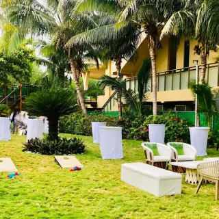 Garden wedding reception lounge with cocktail tables and lawn games at Generations Riviera Maya