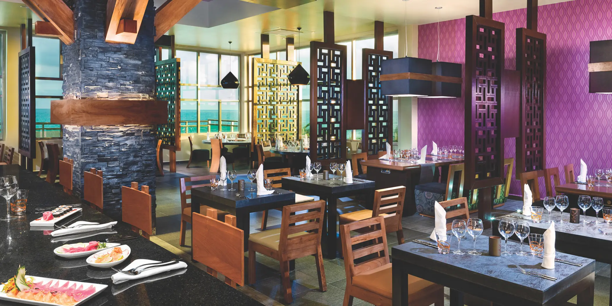 Jade restaurant dining room with purple walls and ocean views at Generations Riviera Maya