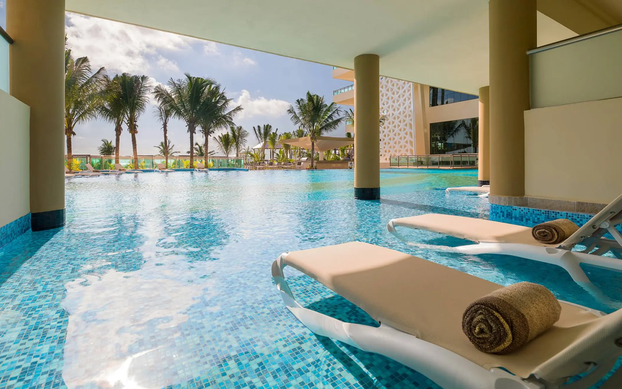 Swim-up suite pool with lounge chairs at Generations Riviera Maya