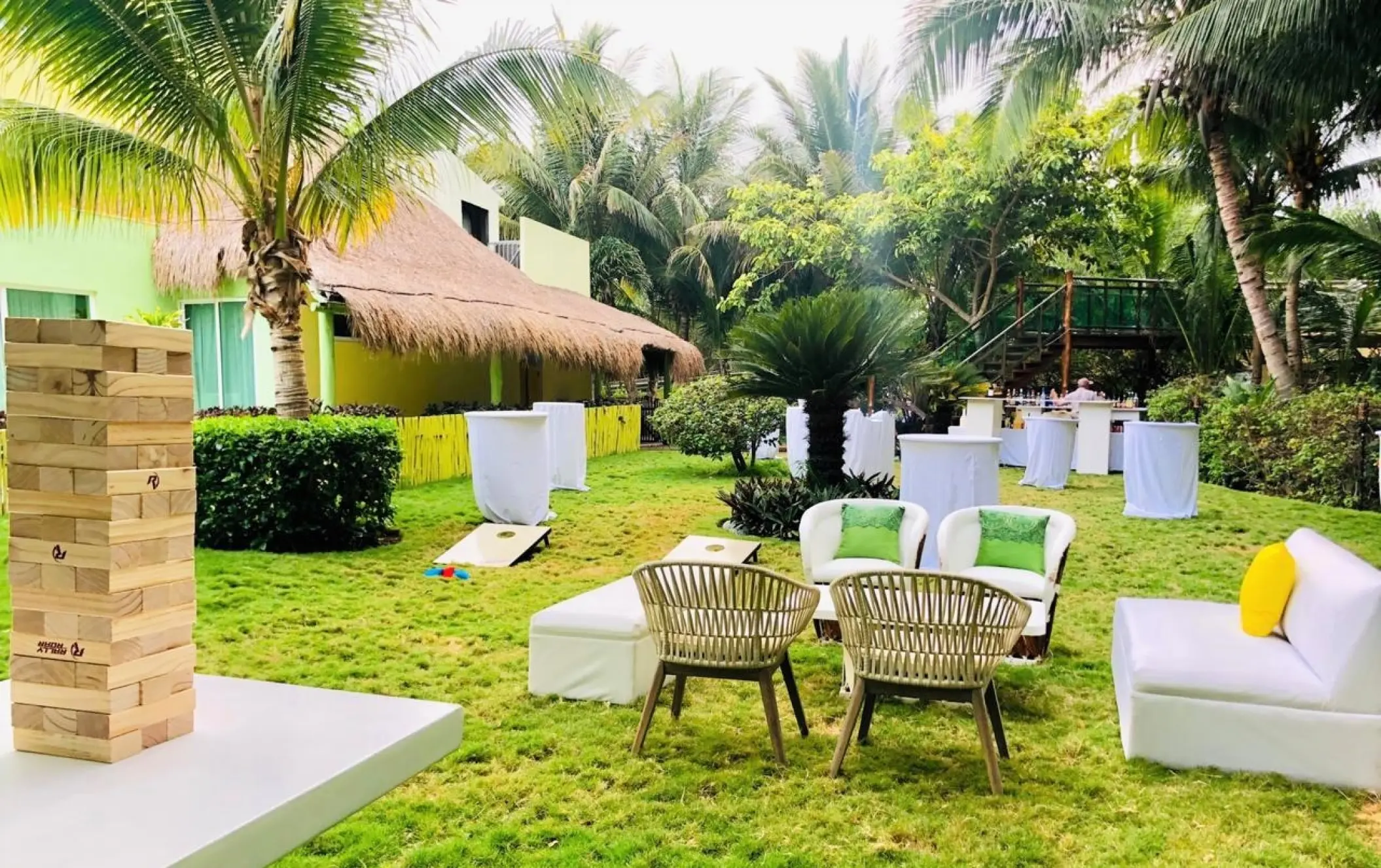 Garden wedding reception lounge with giant wooden blocks and lawn games at Generations Riviera Maya