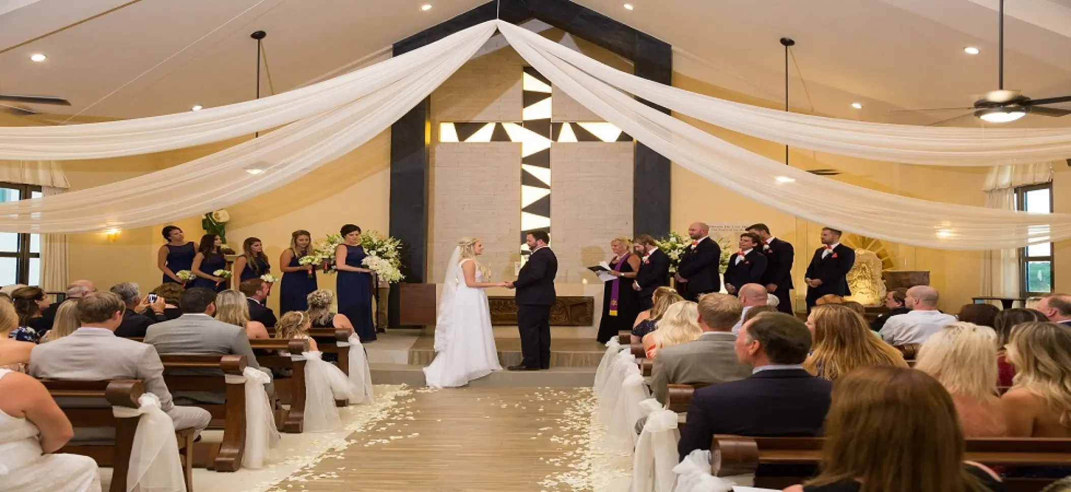 Chapel wedding ceremony with white fabric draping at Generations Riviera Maya