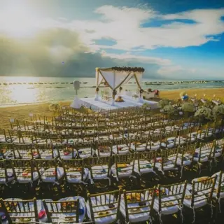 Beachfront wedding ceremony with curved chair rows at Generations Riviera Maya