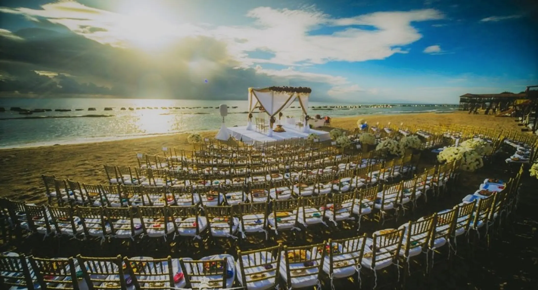 Beachfront wedding ceremony with curved chair rows at Generations Riviera Maya